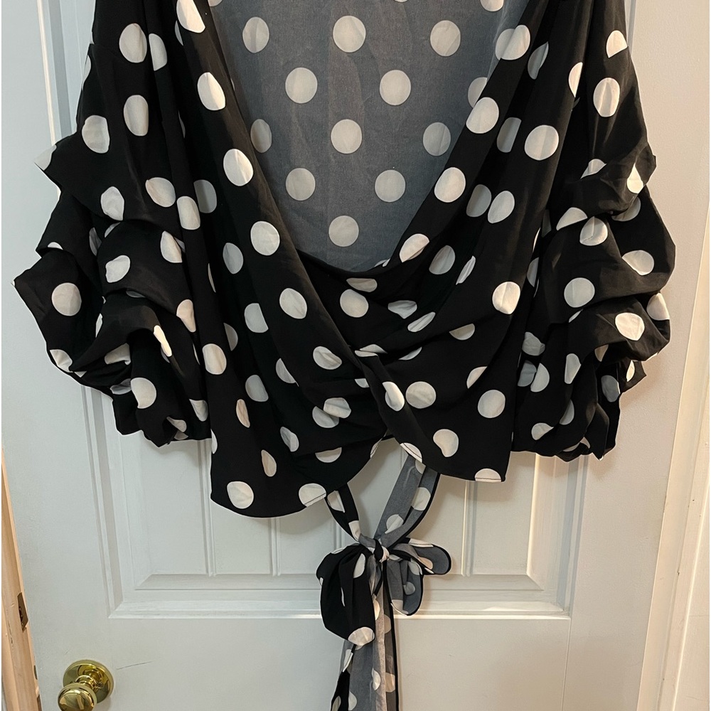 Black and white polkadot wrap top .
